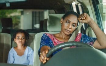 a woman and a child sitting in a car