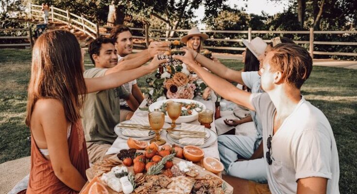 people sitting on chair eating food during daytime