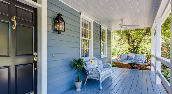 a porch with two chairs and a table on it