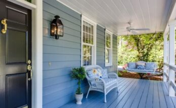 a porch with two chairs and a table on it