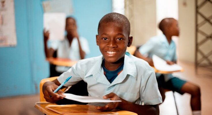 boy holding white paper