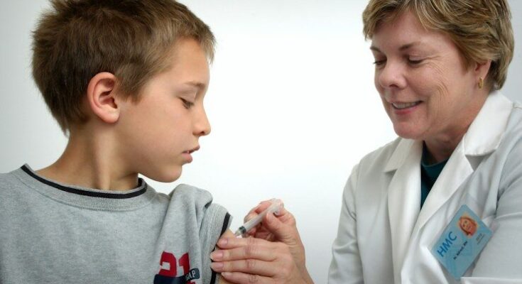 woman inject boy on arm