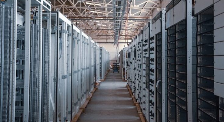 server room aisle with metal equipment racks