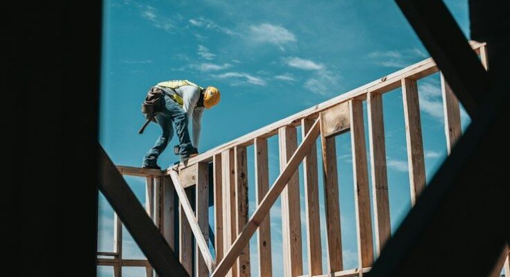 construction worker in hard hat on building frame