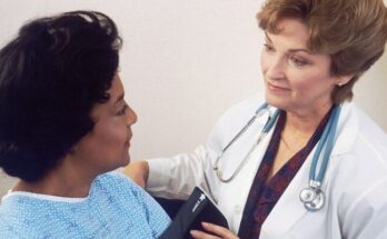 a woman with a stethoscope talking to another woman