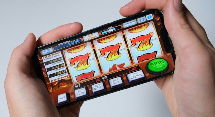 Someone is playing a mobile slot machine game