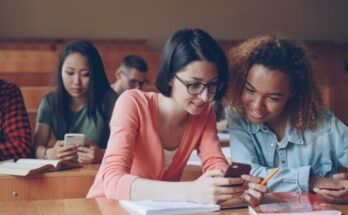 Students looking at phones in a lecture hall