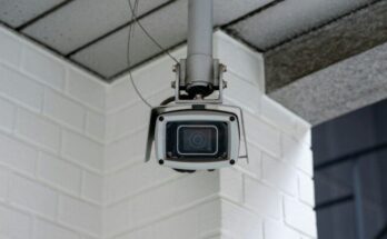 Security camera mounted on a white brick wall