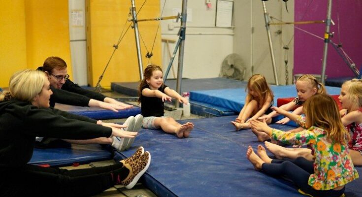 a group of people sitting on mats